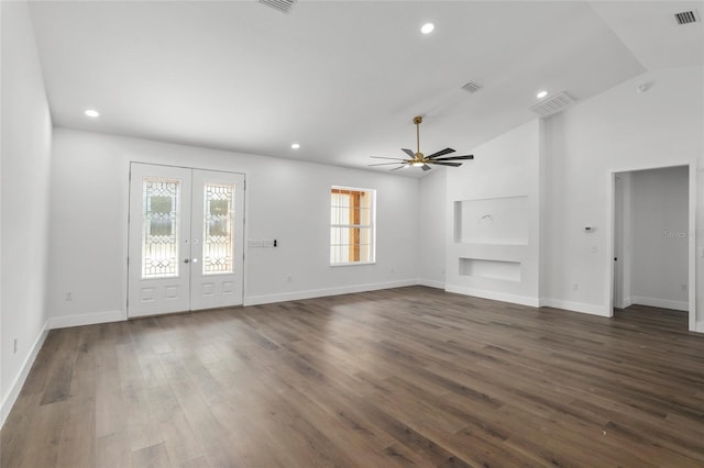 unfurnished living room featuring french doors, ceiling fan, dark hardwood / wood-style flooring, and vaulted ceiling