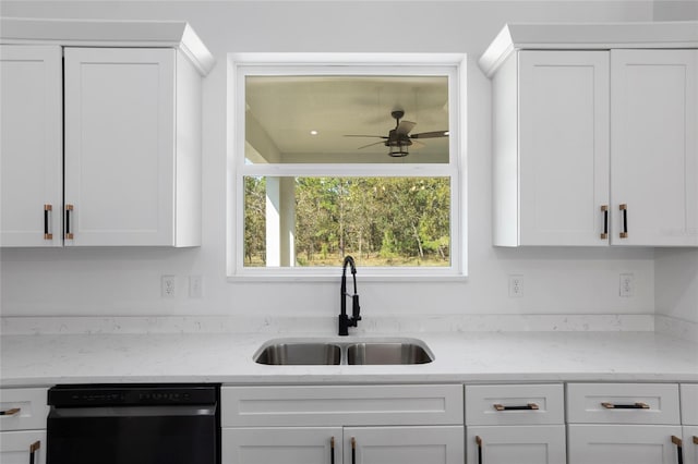 kitchen with sink, ceiling fan, light stone countertops, dishwashing machine, and white cabinetry