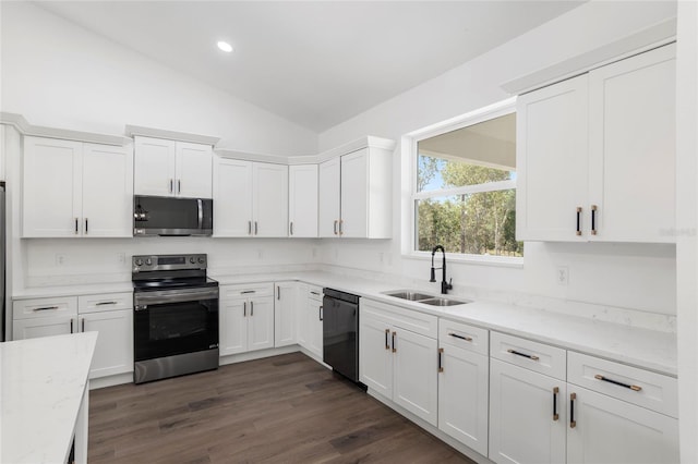 kitchen featuring white cabinetry, sink, stainless steel appliances, dark hardwood / wood-style floors, and lofted ceiling