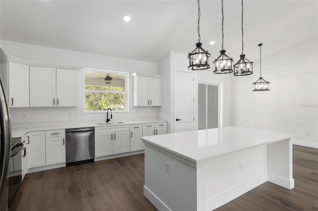 kitchen with dishwasher, a center island, pendant lighting, white cabinets, and ceiling fan with notable chandelier