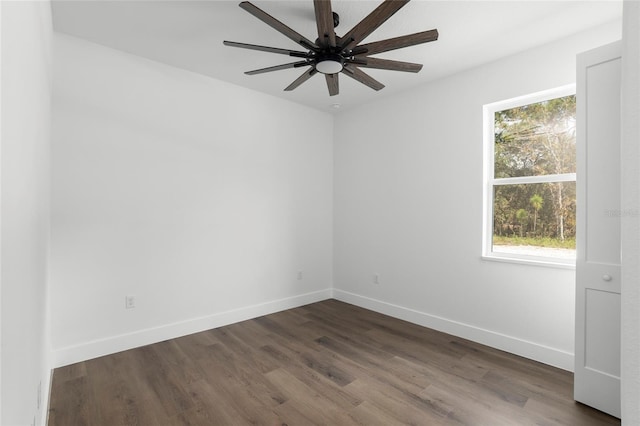 unfurnished room featuring ceiling fan, dark wood-type flooring, and a healthy amount of sunlight