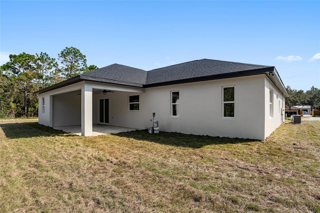 rear view of property featuring a lawn, ceiling fan, a patio, and central AC unit