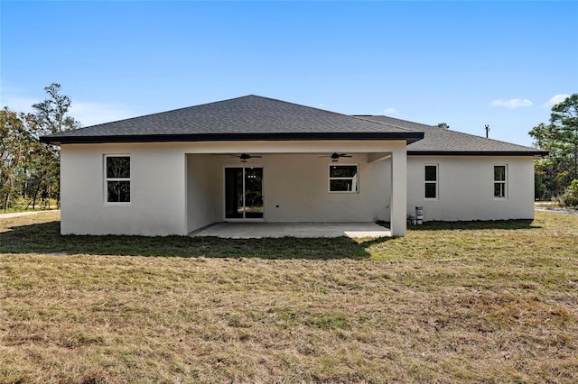 back of property with a lawn, ceiling fan, and a patio