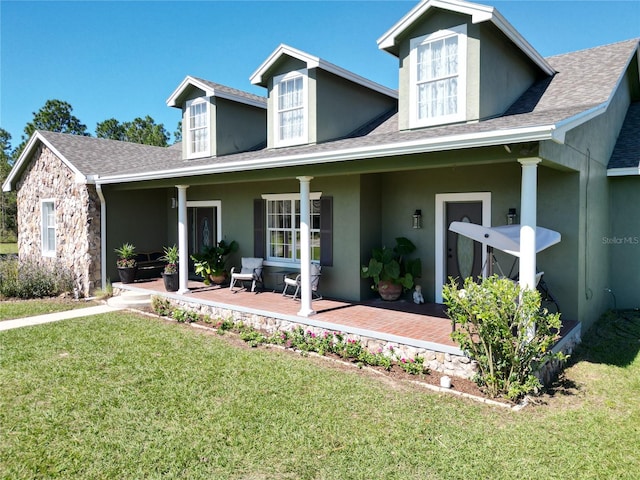 view of front facade with covered porch and a front yard