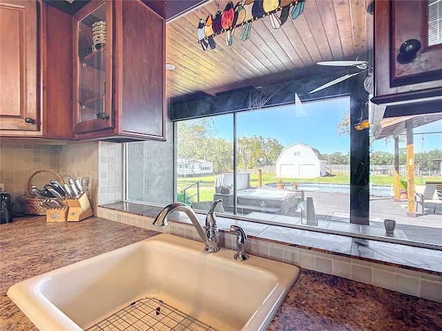 kitchen featuring wood ceiling, sink, and backsplash