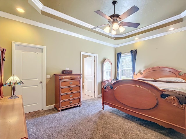 carpeted bedroom with ornamental molding, a raised ceiling, and ceiling fan