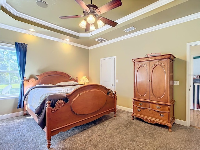 bedroom featuring ornamental molding, a tray ceiling, carpet flooring, and ceiling fan