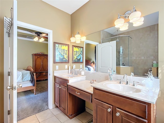 bathroom featuring vanity, ceiling fan, tiled shower, and tile patterned flooring