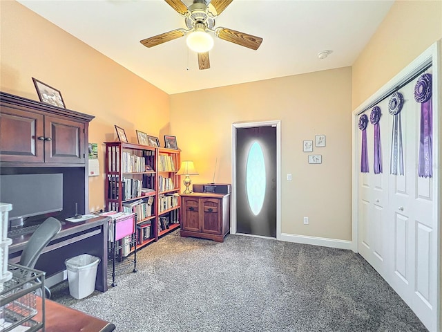 office with dark carpet and ceiling fan