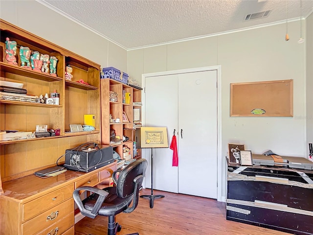 office space featuring crown molding, a textured ceiling, and hardwood / wood-style floors