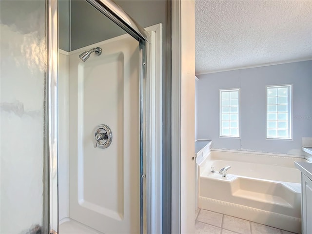 bathroom with vanity, a textured ceiling, tile patterned flooring, and plus walk in shower