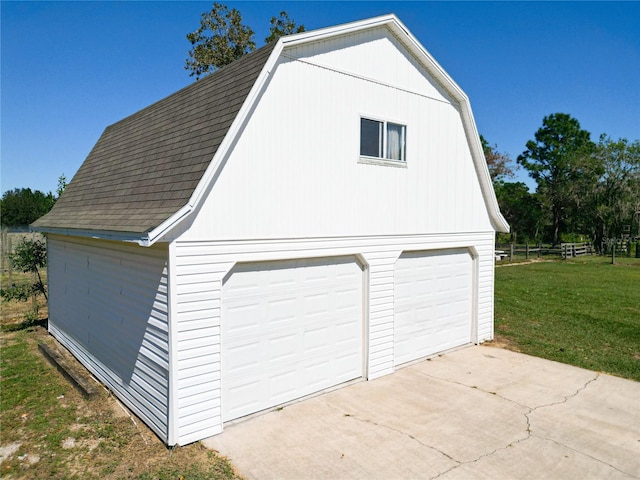 garage featuring a lawn