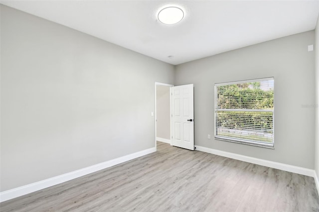 spare room featuring light wood-type flooring