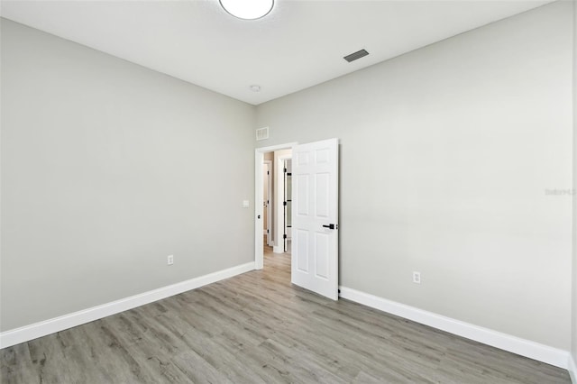 spare room with wood-type flooring