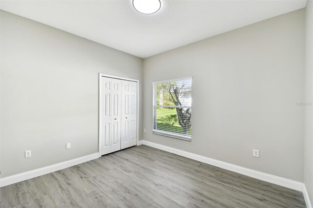 unfurnished bedroom featuring a closet and wood-type flooring