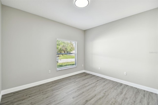 spare room featuring wood-type flooring