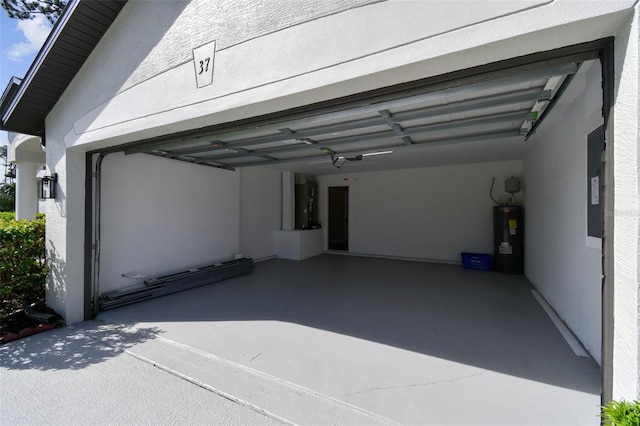 garage featuring electric water heater and electric panel