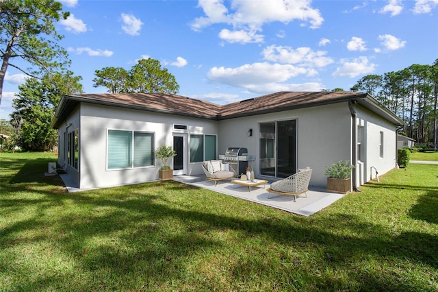 back of property with a patio area and a lawn