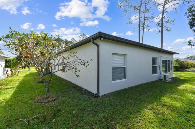 view of home's exterior featuring a yard and central air condition unit