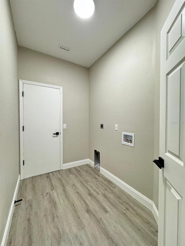 washroom featuring hookup for an electric dryer, hookup for a washing machine, and light hardwood / wood-style floors