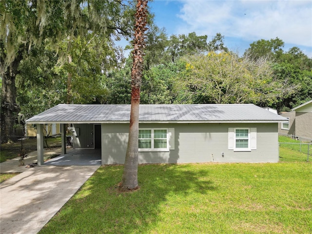 exterior space with a front lawn and a carport