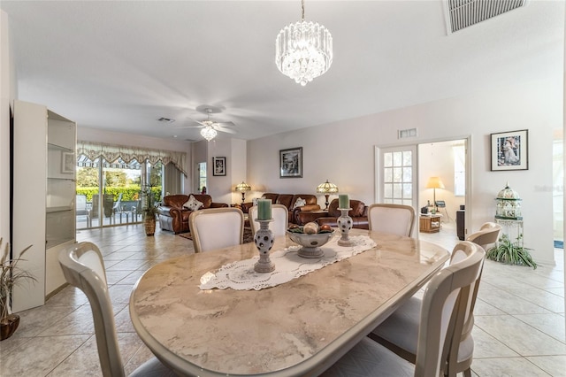 dining area featuring light tile patterned flooring and ceiling fan with notable chandelier