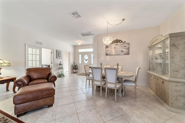 tiled dining area with a wealth of natural light and a chandelier