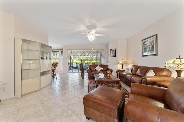 living room with ceiling fan and light tile patterned floors