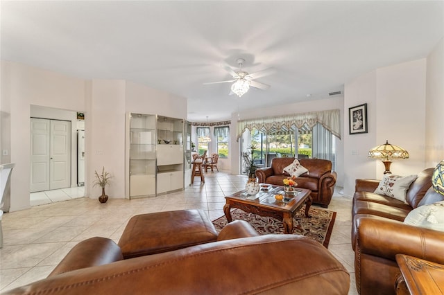 living room featuring ceiling fan and light tile patterned floors