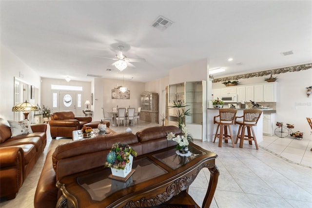 tiled living room featuring ceiling fan