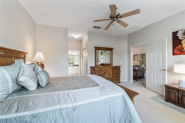 bedroom featuring light carpet, ensuite bath, and ceiling fan