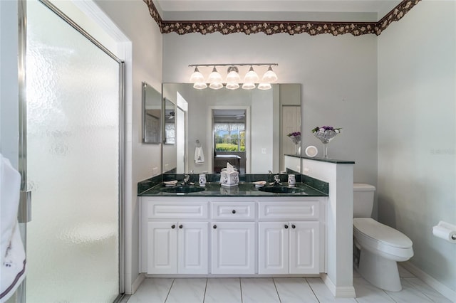 bathroom featuring toilet, vanity, and a shower with door