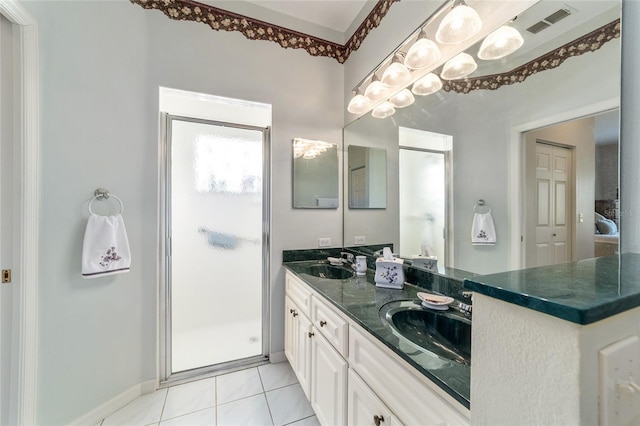 bathroom featuring vanity, tile patterned floors, and a shower with shower door