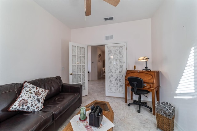 living room featuring light tile patterned floors and ceiling fan