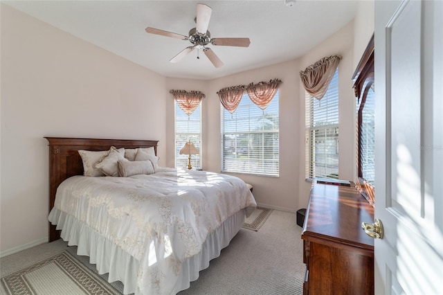 bedroom featuring ceiling fan and light colored carpet