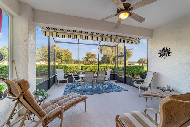 sunroom featuring ceiling fan