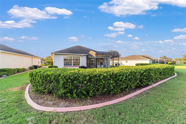 rear view of property featuring a lawn and a pergola