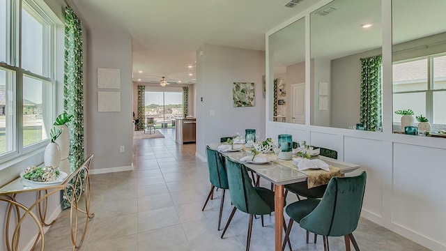 dining space featuring light tile patterned flooring and ceiling fan