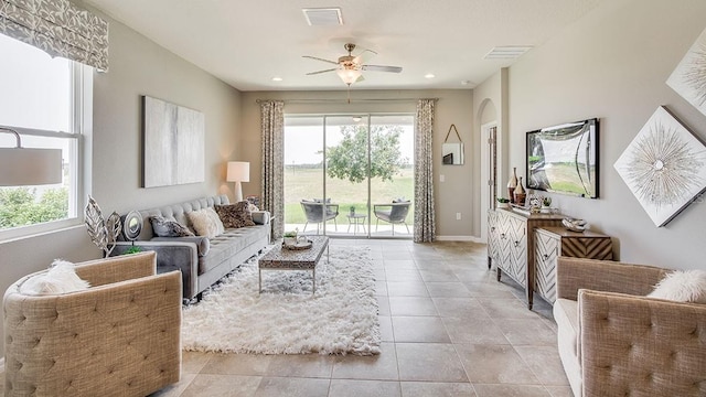 tiled living room with ceiling fan