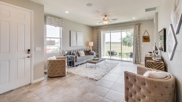 tiled living room featuring ceiling fan