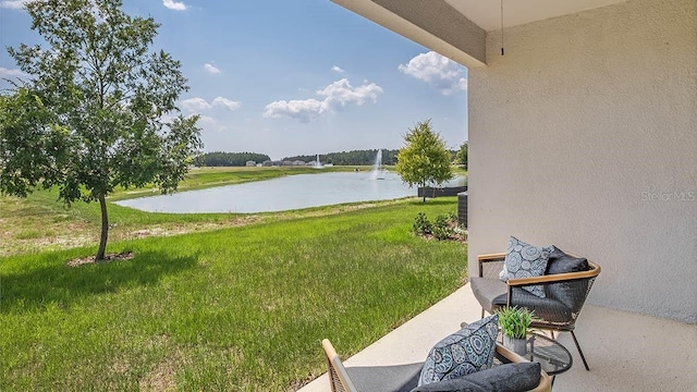 view of yard featuring a water view and a patio area