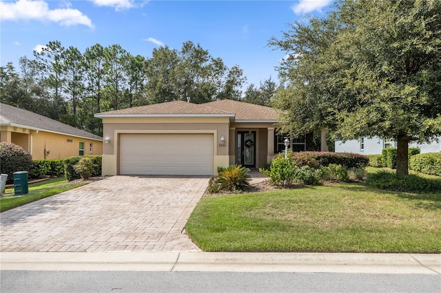 view of front of home with a garage and a front lawn