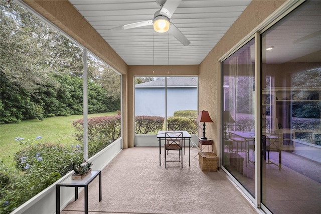 sunroom / solarium featuring ceiling fan