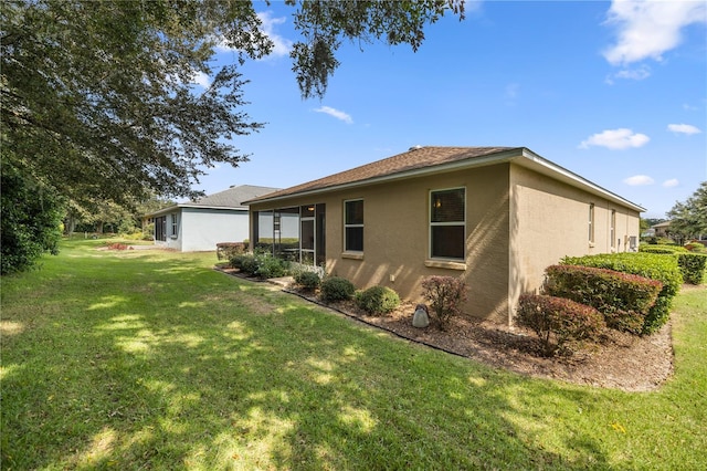 view of side of home with a yard