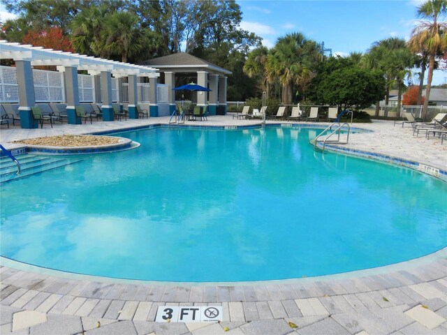 view of swimming pool with a patio area