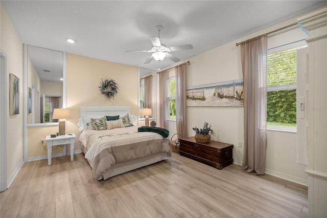 bedroom with light hardwood / wood-style flooring and ceiling fan