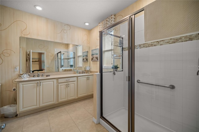 bathroom with tile patterned floors, vanity, and a shower with door