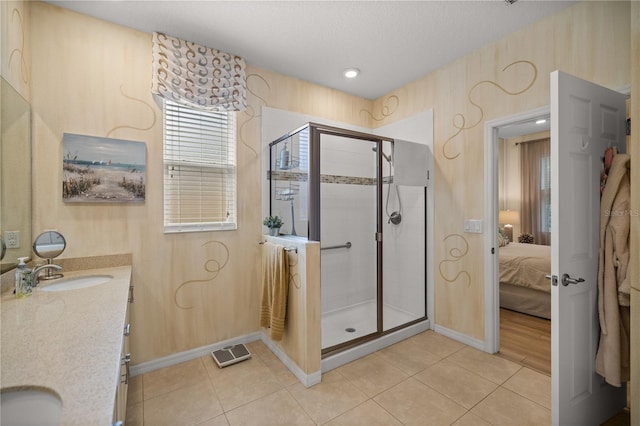 bathroom with tile patterned flooring, vanity, and a shower with shower door