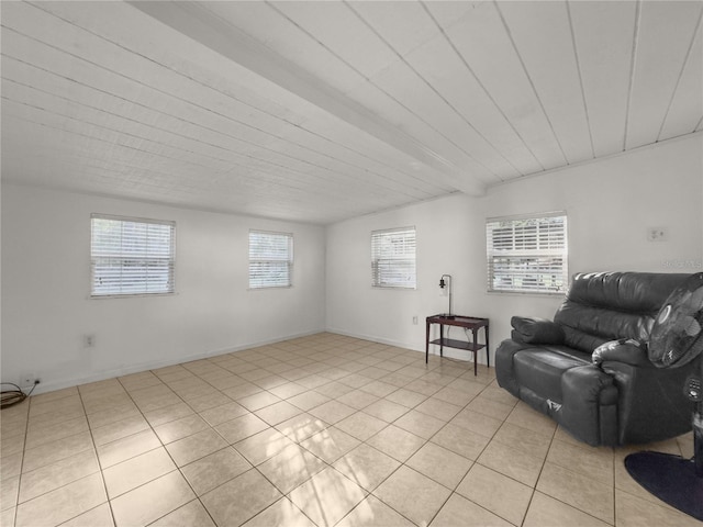 sitting room featuring beamed ceiling and light tile patterned floors