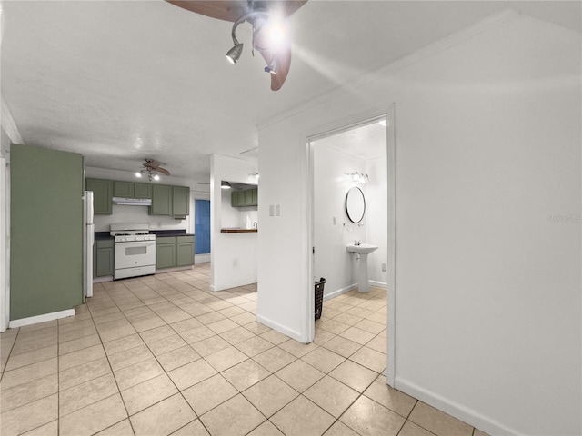 kitchen with white appliances, light tile patterned flooring, green cabinetry, ceiling fan, and ornamental molding